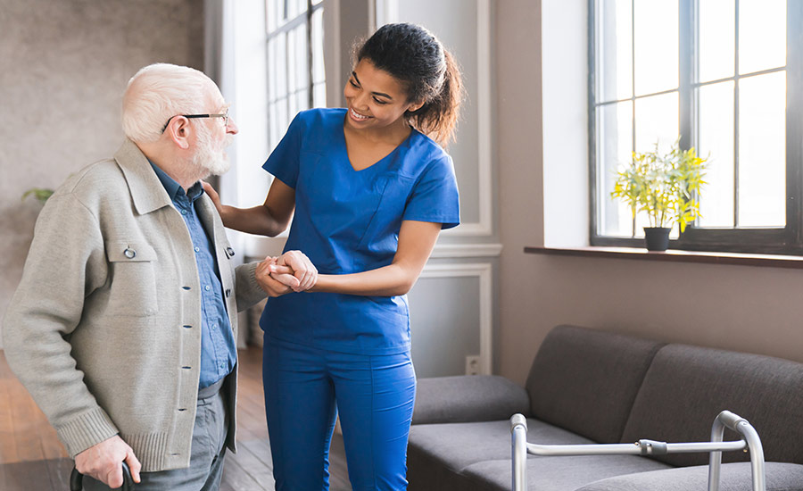 Carer helping elderly person at home